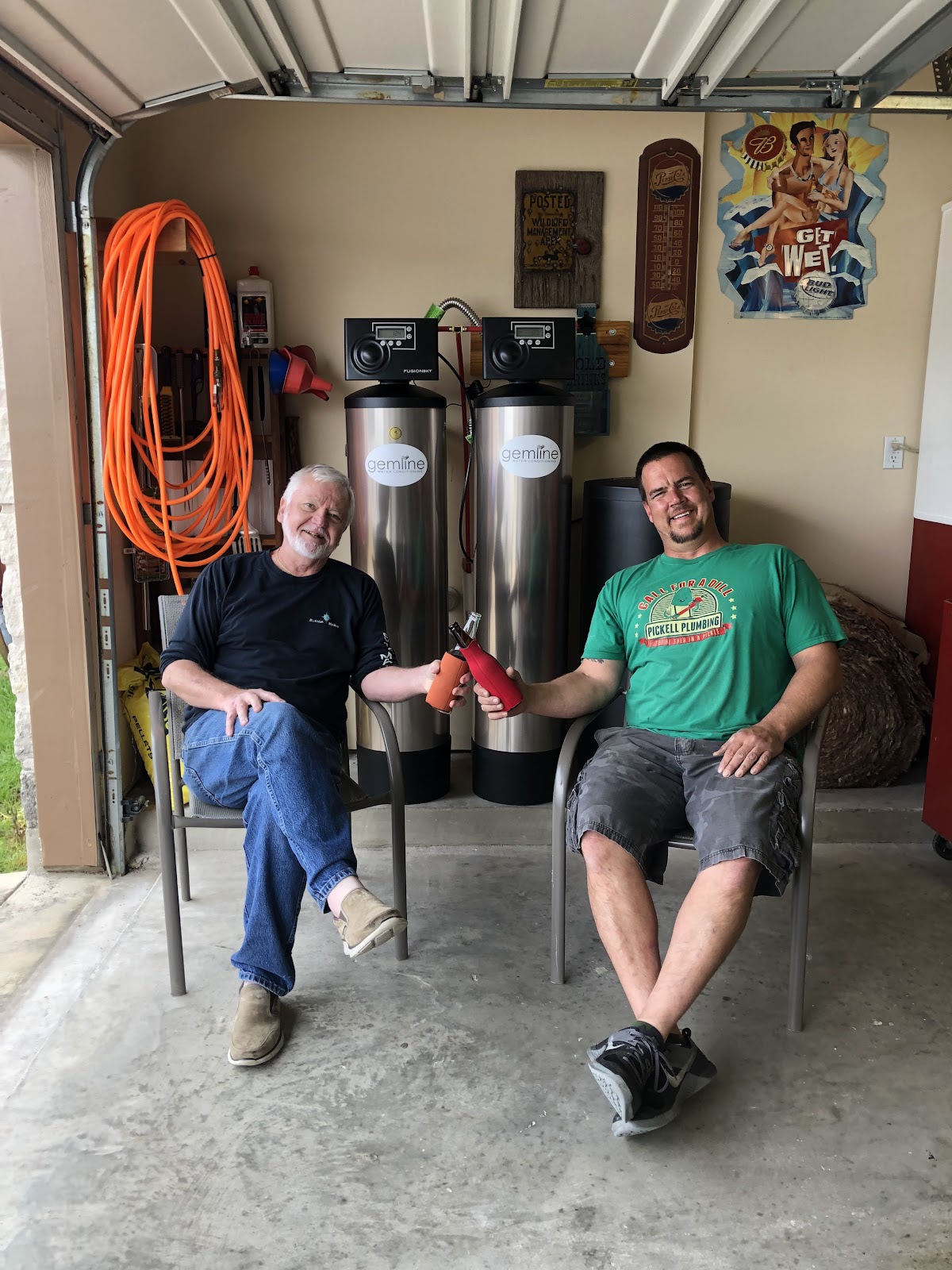 A Pickell Plumbing technician with a happy customer after a finished water softener install