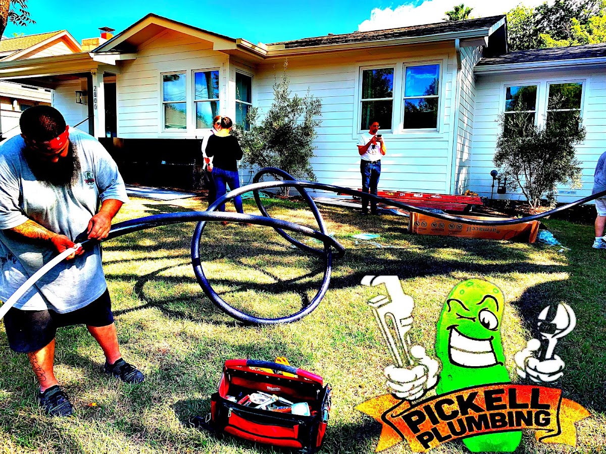 Pickell Plumbing crew running a new water line across a yard